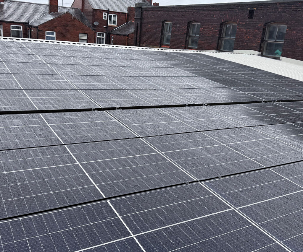 Commercial-scale solar-hybrid renewable energy system installed on the roof of an industrial manufacturing building